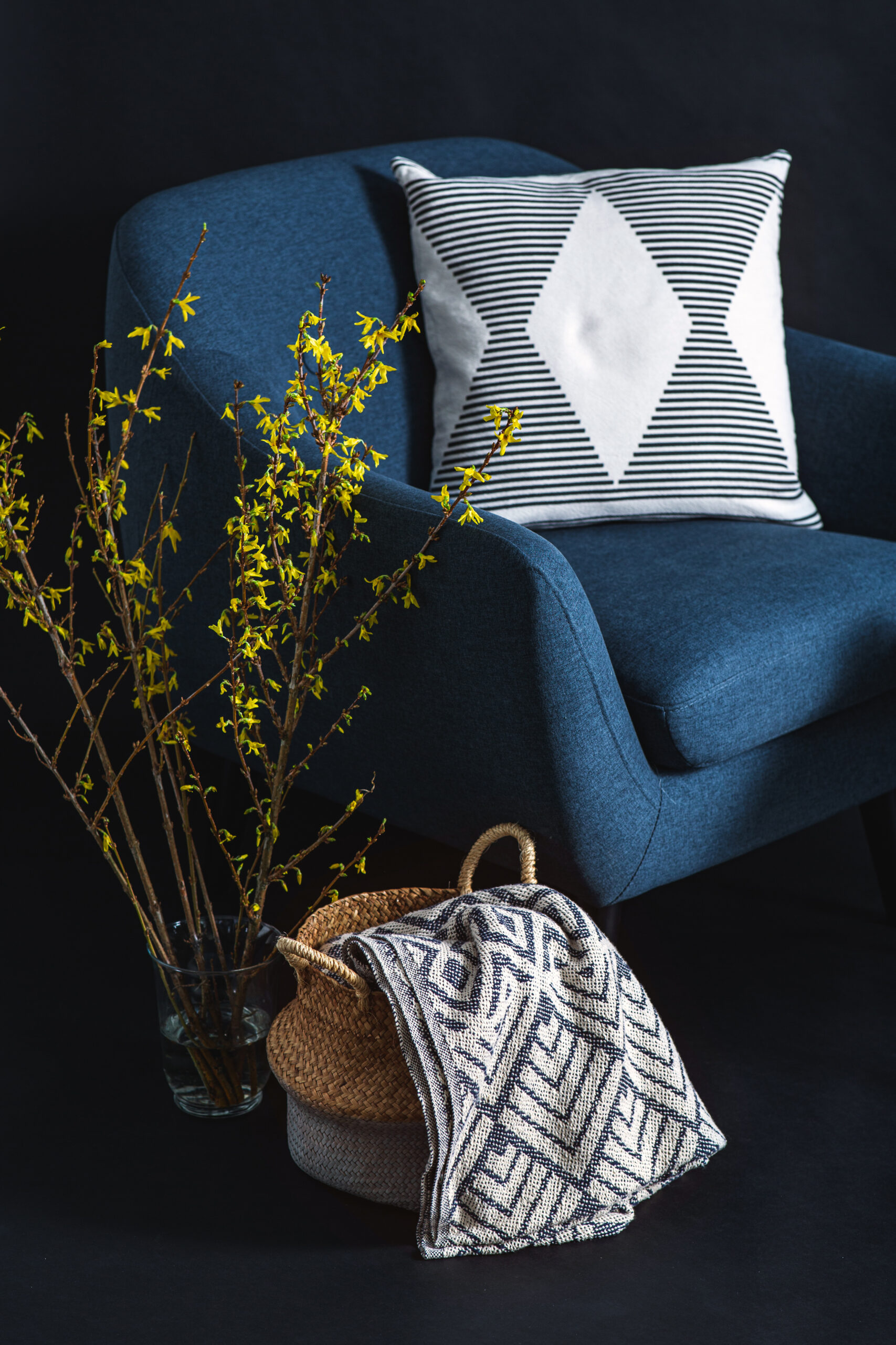 decor blue chair with pillow and throw AdobeStock 562485387 scaled